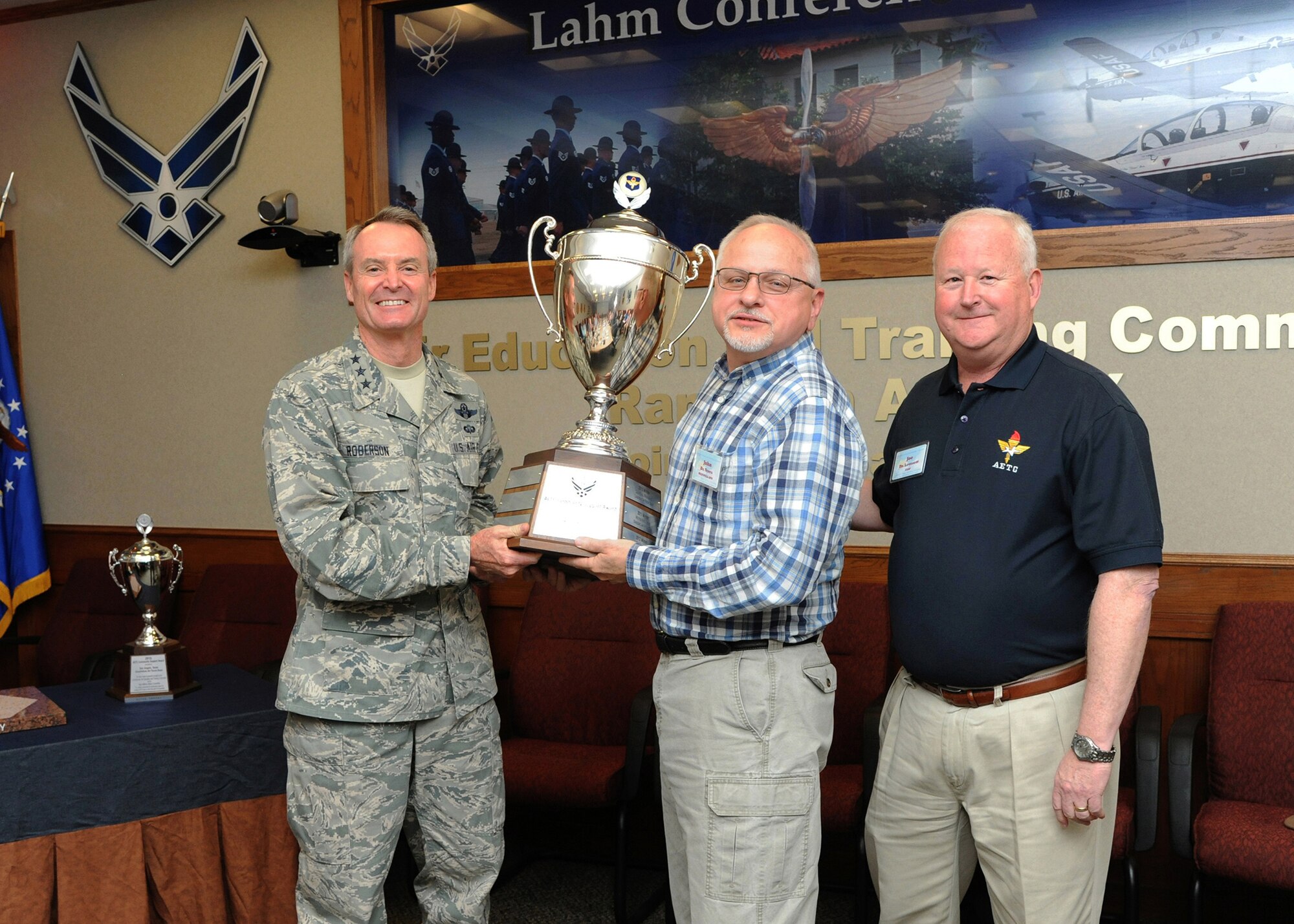 Lt. Gen. Darryl Roberson, commander of Air
Education and Training Command, and Joe Leverett (right), chairman of the
Altus Trophy selection committee, present the 2015 Altus Trophy to Dr. John
Veres III (center), chancellor of Auburn University Montgomery, Alabama,
March 23 at Joint Base San Antonio-Randolph, Texas. Roberson announced
Montgomery, Alabama, as the 2015 Altus Trophy winner during the AETC
Commander's Civic Leader Group Spring Meeting here. (U.S. Air Force photo by
Melissa Peterson)
