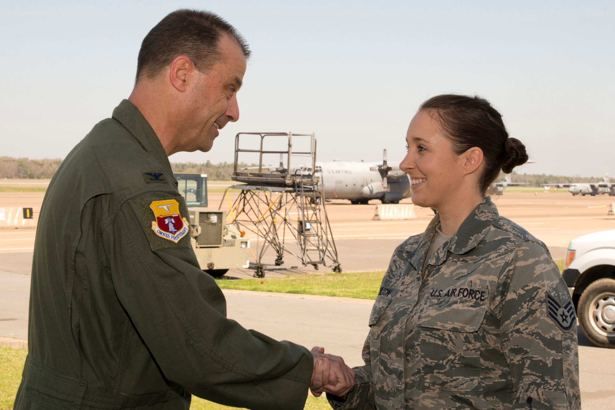 U.S. Air Force Reserve Col. Craig Drescher, 913th Airlift Group commander, congratulates Staff Sgt. Tamara Hamilton, a 913th Maintenance Squadron crew chief, as the Combat Airlifter of the Week Mar. 15, 2016, at Little Rock Air Force Base, Ark. Hamilton saved the Air Force $12,000 by volunteering to build an engine trailer out of salvageable items. (U.S. Air Force photo by Master Sgt. Jeff Walston/Released)  