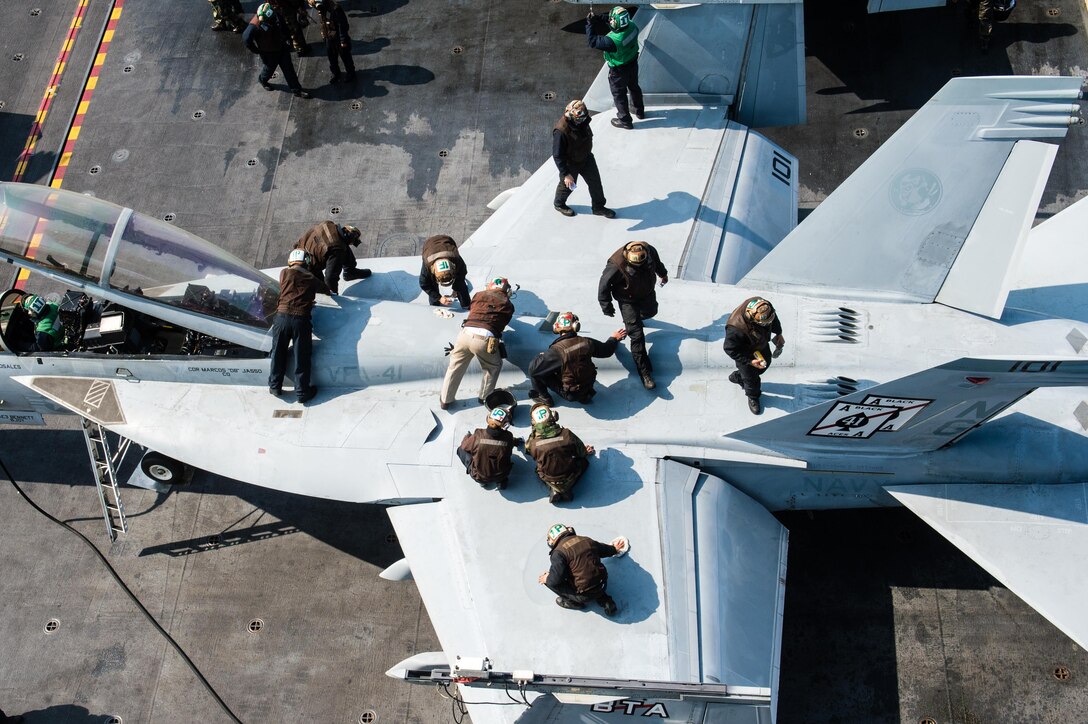 Sailors clean an F/A-18F Super Hornet on the flight deck of the aircraft carrier USS John C. Stennis near the Korean peninsula, March 23, 2016. The Super Hornet is assigned to Strike Fighter Squadron 41. The Stennis is on a regularly scheduled deployment to the U.S. 7th Fleet area of responsibility. Navy photo by Petty Officer 3rd Class Andre T. Richard