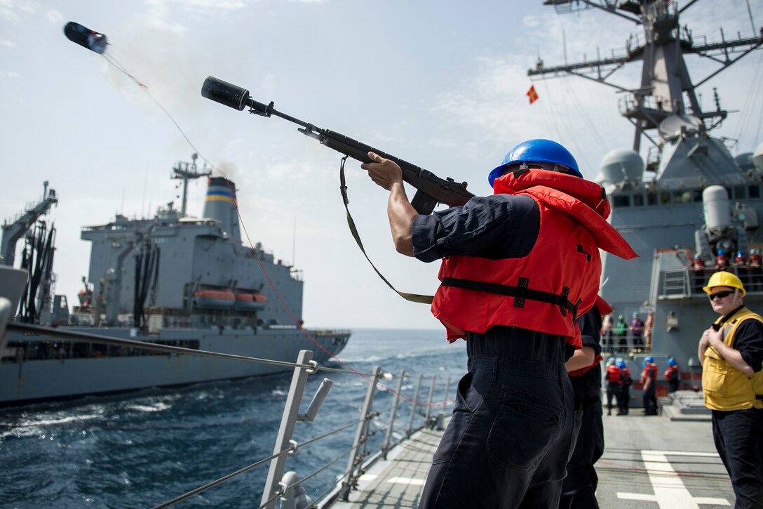 Navy Seaman Jesse Savage fires a shot line from the guided-missile destroyer USS Gonzalez in the Arabian Gulf, March 16, 2016. The Gonzalez is supporting Operation Inherent Resolve in the U.S. 5th Fleet area of responsibility. Navy photo by Petty Officer 3rd Class Pasquale Sena