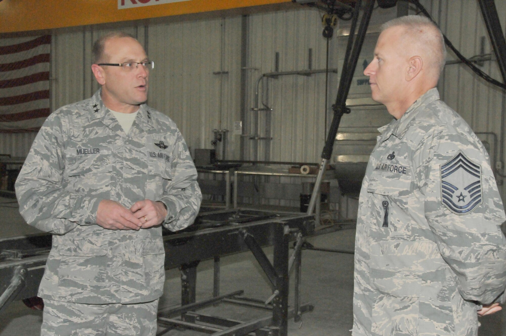 Maj. Gen. Andrew Mueller (left), Air Force Chief of Safety, speaks with Chief Master Sgt. Sandy Browning (right), 379th Expeditionary Maintenance Squadron munitions flight chief, about the flight's mission at Al Udeid Air Base, Qatar March 16. Browning also talked about how the ammunition’s flight ensures their three and five-skill level service members continue to meet training requirements, even while working in an expeditionary environment. (U.S. Air Force photo by Tech. Sgt. Terrica Y. Jones/Released)