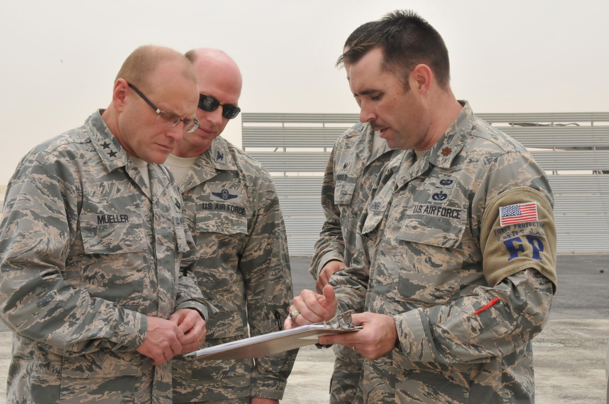 Maj. Gen. Andrew Mueller (left), Air Force Chief of Safety, discusses flight line construction with Maj. Robert Barnes (right), 379th Expeditionary Civil Engineer Squadron deputy commander, March 16 at Al Udeid Air Base, Qatar. Barnes briefed Muller on the 379th ECES and 1st Expeditionary Civil Engineer Group repairs of the close air support ramp and taxiway to minimize risks to aircraft operations, as well as steps taken to mitigate other potential hazards. (U.S. Air Force photo by Tech. Sgt. Terrica Y. Jones/Released)