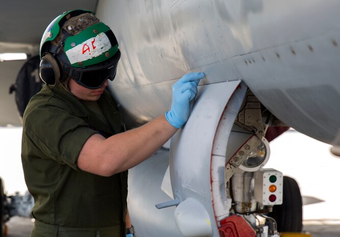 Lance Cpl. Lestat Lanier, an airframer with Marine Fighter Attack Squadron (VMFA) 122, scrapes letters off an F/A-18C at Marine Corps Air Station Iwakuni, Japan, March 22, 2016. VMFA-122, also known as the “Werewolves,” arrived at MCAS Iwakuni March 14 from MCAS Beaufort, S. C., for a six month rotation with the unit deployment program. The Werewolves squadron will conduct contingency, bilateral and multilateral training with their Japanese counterparts and services. (U.S. Marine Corps photo by Cpl. Nicole Zurbrugg/Released)