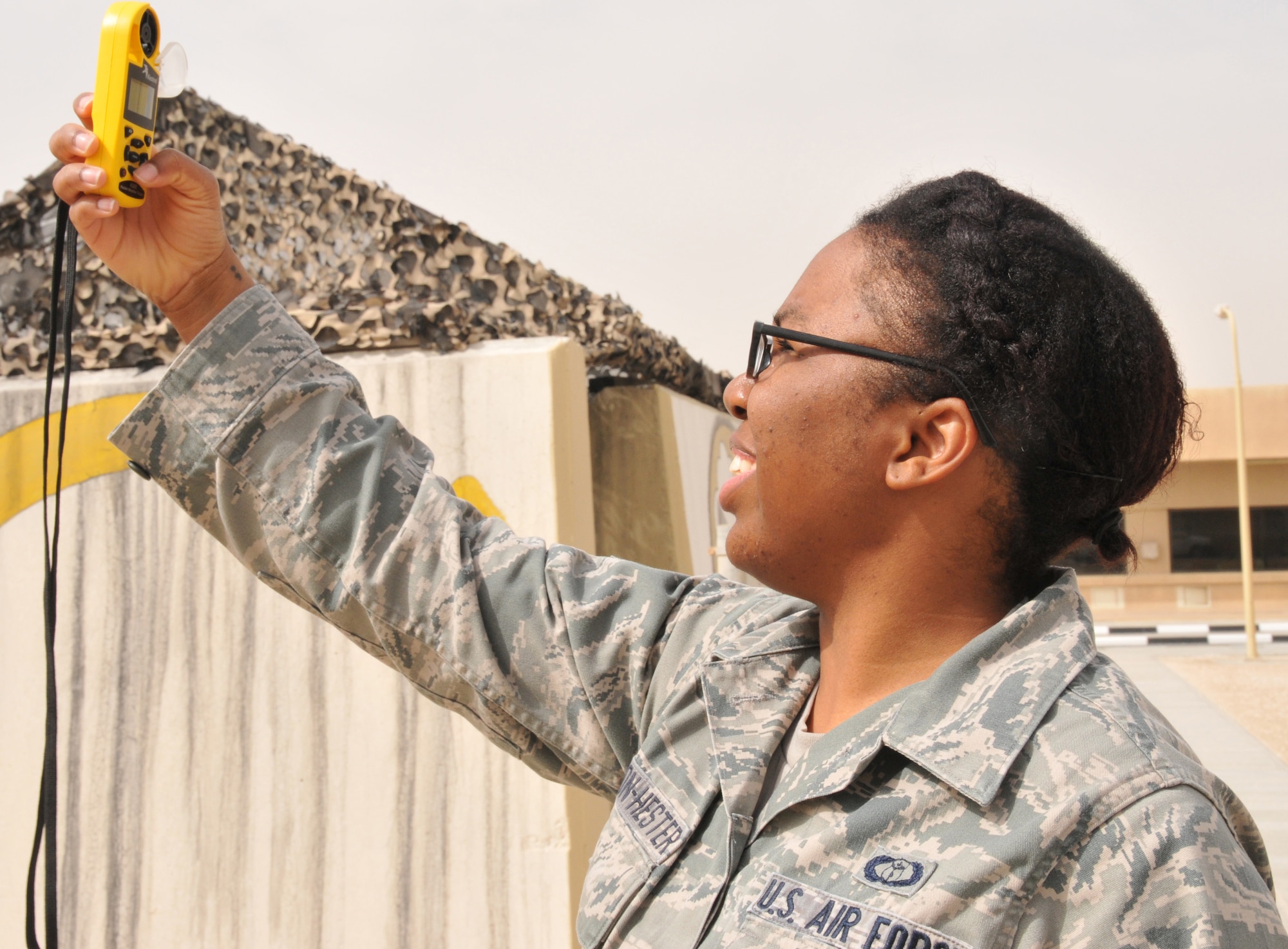 Senior Airman Tania Johnson-Hester, 379th Expeditionary Operations Support Squadron weather forecaster, uses a Kestrel 4500, a pocket weather tracker, March 17 at Al Udeid Air Base, Qatar. Some of the readings a Kestrel 4500 can take are temperature, dew point, wind speed, and humidity. (U.S. Air Force photo by Tech. Sgt. Terrica Y. Jones/Released)
