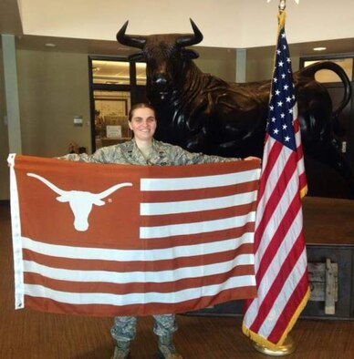 Former Bosnian refugee and 379th Expeditionary Civil Engineer Squadron operations engineering officer-in-charge, 1st Lt. Amela Kamencic holds up her university flag. 