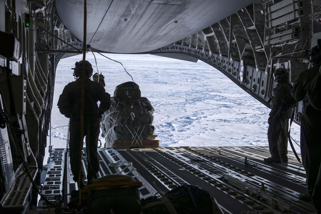 Air Force airmen deploy a package out of a C-17 Globemaster III aircraft over Ice Camp Sargo to support Ice Exercise 2016 in the Arctic Circle, March 15, 2016. The airmen are loadmasters assigned to the 249th Airlift Squadron. ICEX is a joint-force exercise which allows multiple military branches to assess readiness in the Arctic, increase operation experience in the region, develop partnerships and collaborative efforts, and advance understanding of the Arctic environment. Air Force photo by Staff Sgt. Wes Wright
