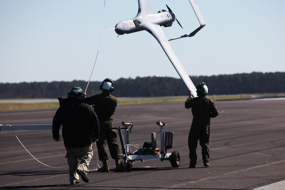 Marines with Marine Unmanned Aerial Vehicle Squadron 2 retrieve a RQ-21A Blackjack after recovery at Marine Corps Air Station Cherry Point, N.C., March 21, 2016. The RQ-21A Blackjack system is modular, flexible and multi-mission capable, providing roll-on, roll-off transitions between land and maritime environments. The aircraft was launched for the first time into Class D airspace over MCAS Cherry Point. (U.S. Marine Corps photo by Pfc. Nicholas P. Baird/Released)