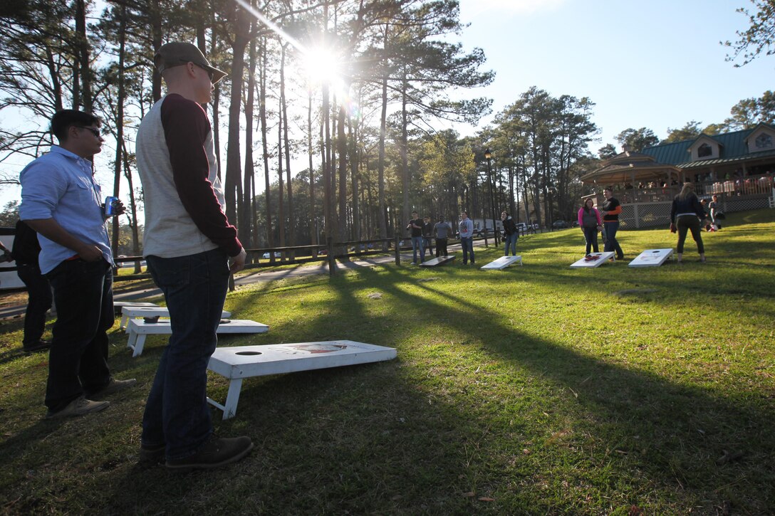 Marines with Marine Attack Training Squadron 203 and their family members play a game of bean bag toss game during the simiannual pig pickin’ at Marine Corps Air Station Cherry Point, N.C., March 22, 2016. More than 300 Marines, family members and members of the Havelock community attended the event. The event was held to show the community’s appreciation to the Marines and thank the service members on Cherry Point for their contributions to the Marine Air-Ground Task Force. (U.S. Marine Corps photo by Pfc. Nicholas P. Baird/Released)