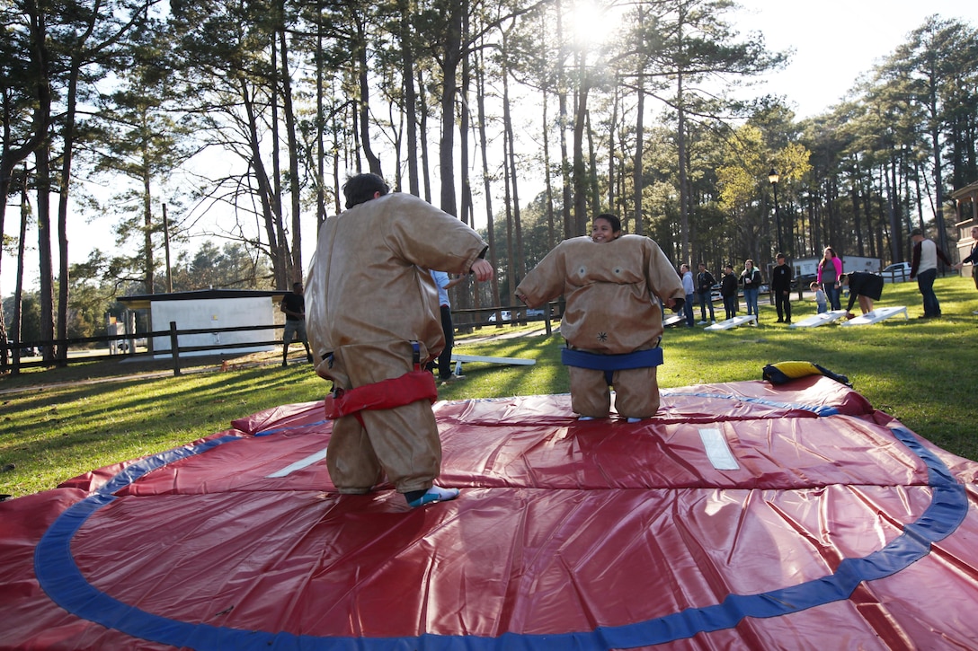 Cole, left, and Noah Sumo wrestle during the simiannual pig pickin’ at Marine Corps Air Station Cherry Point, N.C., March 22, 2016. More than 300 Marines, family members and members of the Havelock community attended the event. The event was held to show the community’s appreciation to the Marines and thank the service members on Cherry Point for their contributions to the Marine Air-Ground Task Force. (U.S. Marine Corps photo by Pfc. Nicholas P. Baird/Released)