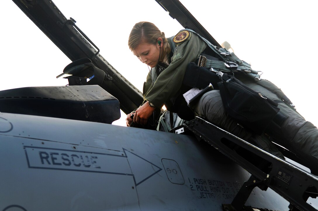 Air Force 1st Lt. Brittany Trimble plugs her flight equipment into an F-16 Fighting Falcon aircraft before takeoff at Korat Royal Thai Air Force Base, Thailand, March 15, 2016.  Air Force photo by Staff Sgt. Amber E. Jacobs 