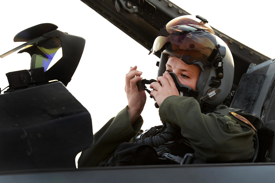 Air Force 1st Lt. Brittany Trimble secures her pilot helmet inside the cockpit of an F-16 Fighting Falcon aircraft before takeoff at Korat Royal Thai Air Force Base, Thailand, March 15, 2016. Trimble is a pilot assigned to the 36th Fighter Squadron. Air Force photo by Staff Sgt. Amber E. Jacobs