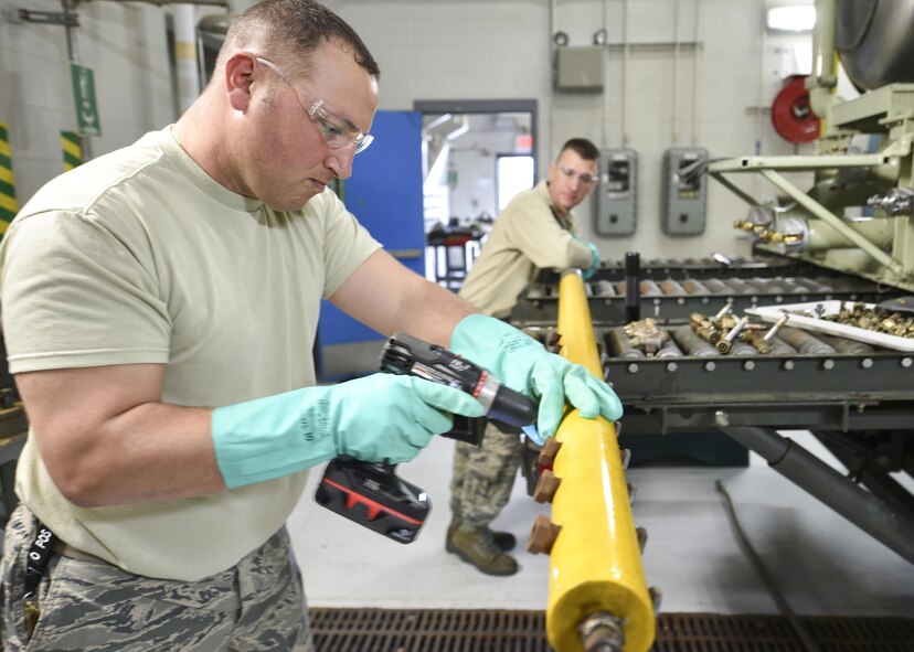 Tech. Sgt. Frank Serrao, an aerial spray maintenance craftsman with the 910th Maintenance Squadron, uses a drill with a brush bit and soap solution to clean nozzle fittings on an aerial spray boom here, March 24. Tech. Sgt. Thomas Neiswanger, also an aerial spray maintenance craftsman, supports the boom while Serrao works. Aerial spray maintainers come from traditional aircraft maintenance jobs, learning a unique skillset through on-job training to maintain the equipment for the Department of Defense’s only aerial spray mission. The aerial spray mission includes insect control, vegetation control on bombing ranges and oil spill neutralization.  (U.S. Air Force photo/Eric M. White)