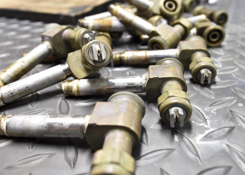 A close-up photo shows aerial spray nozzles set aside for cleaning here, March 24. Tech. Sgt. Frank Serrao and Tech. Sgt. Thomas Neiswanger, aerial spray maintenance craftsmen with the 910th Maintenance Squadron, removed the nozzle to clean and inspect an aerial spray boom assembly. The aerial spray system has several types of nozzles for different applications. The mission includes insect control, vegetation control on bombing ranges and oil spill neutralization. Aerial spray maintainers come from traditional aircraft maintenance jobs, learning a unique skillset through on-job training to maintain the equipment for the Department of Defense’s only aerial spray mission.   (U.S. Air Force photo/Eric M. White)