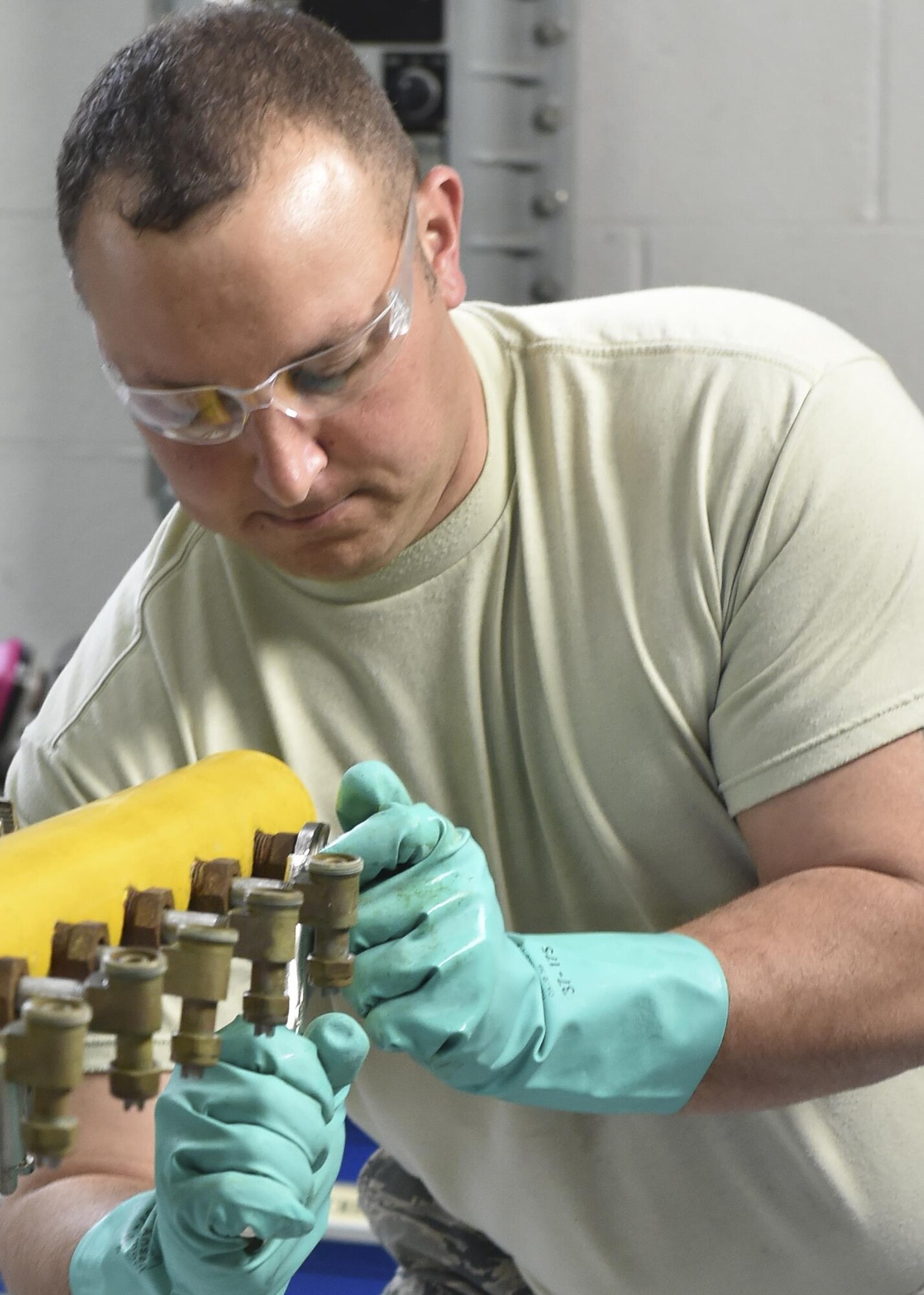 Tech. Sgt. Frank Serrao, an aerial spray maintenance craftsman with the 910th Maintenance Squadron here, loosens the fitting for an aerial spray nozzle so that boom and nozzle may be cleaned and inspected, March 24. Aerial spray maintainers come from traditional aircraft maintenance jobs, learning a unique skillset through on-job training to maintain the equipment for the Department of Defense’s only aerial spray mission. The aerial spray mission includes insect control, vegetation control on bombing ranges and oil spill neutralization.  (U.S. Air Force photo/Eric M. White)