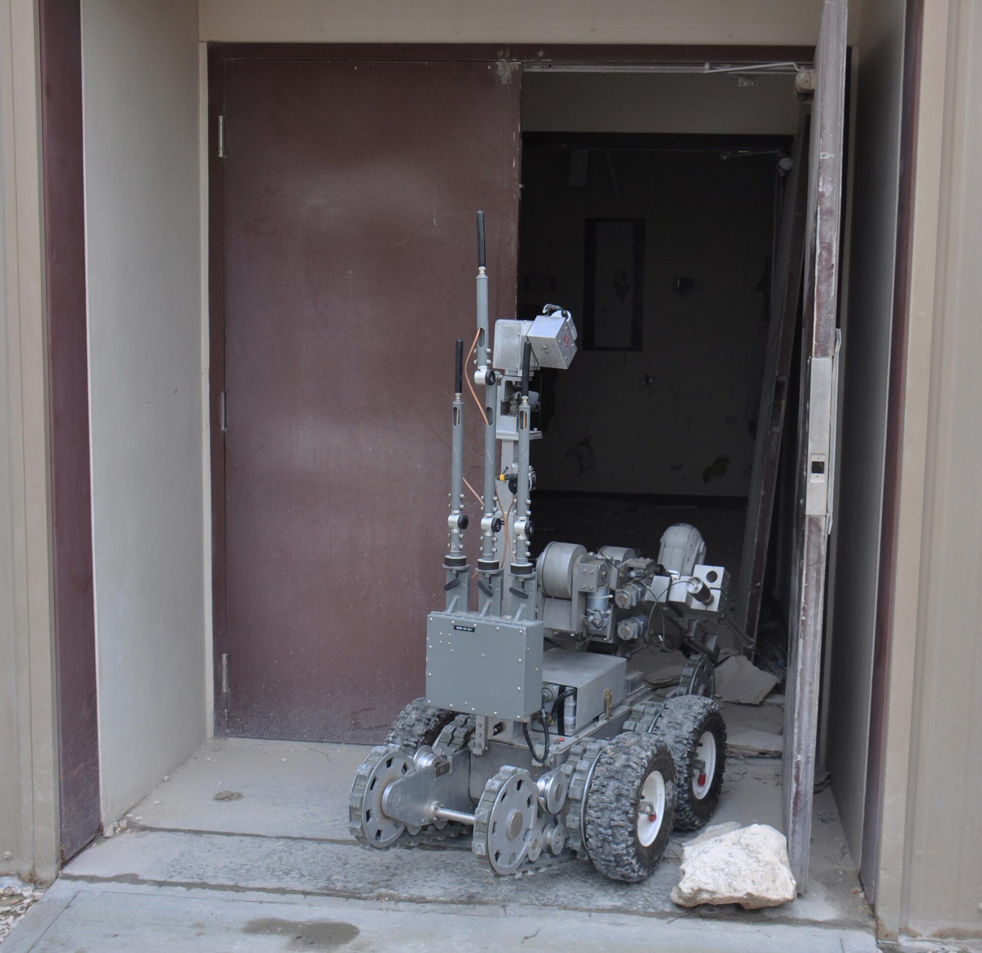An F-6 robot enters a building to search for mock explosives during a hazardous materials exercise at Al Udeid Air Base, Qatar March 16. The robot is assigned to the 379th Expeditionary Civil Engineer Squadron Explosive Ordnance Flight and assists EOD technicians with locating explosives. The training exercise provided first responders an opportunity to practice reacting to an emergency incident. Several emergency personnel participated in the exercise including security forces and medics. (U.S. Air Force photo by Tech. Sgt. James Hodgman/Released)
