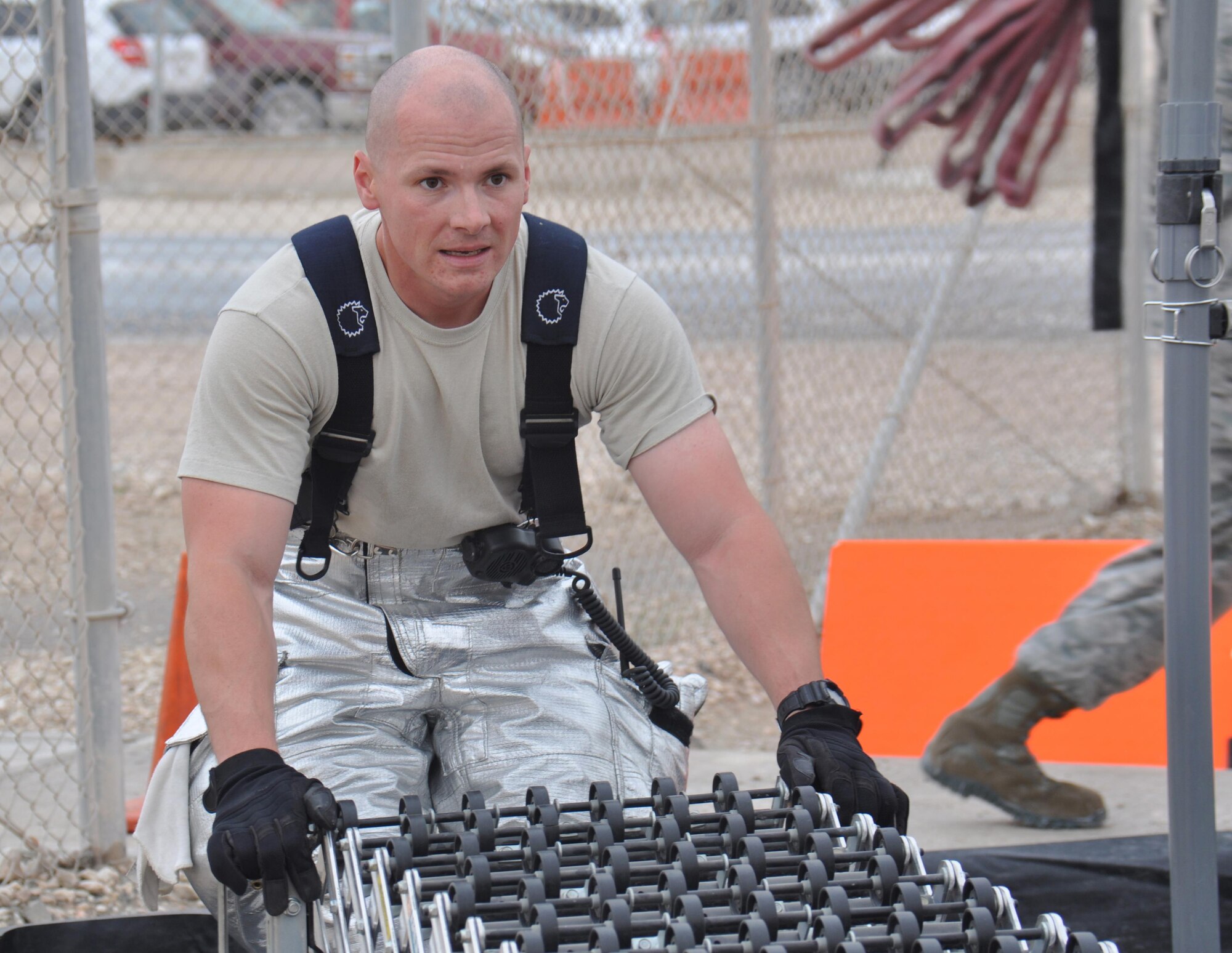 Senior Airman Matthew Petersen, 379th Expeditionary Civil Engineer Squadron firefighter, sets up a conveyer belt inside a decontamination processing area during a hazardous materials exercise at Al Udeid Air Base, Qatar March 16. The training exercise, which featured mock explosives and chemicals, provided first responders an opportunity to practice reacting to an emergency incident. Several emergency personnel participated in the exercise including security forces and medics. (U.S. Air Force photo by Tech. Sgt. James Hodgman/Released)