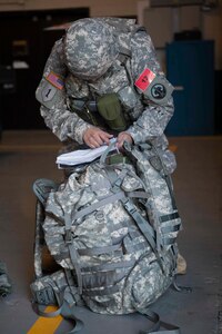 U.S. Army Reserve Careers Divisions' Sgt. First Class Nelson Molinarez orients himself during the urban orienteering event of the joint Best Warrior competition March 22, 2016 on Fort Knox, Kentucky. The Best Warrior Competition is a four-day competition that tests competitors' Army aptitude by going through urban warfare situations, board interviews, physical fitness tests, written exams, Warrior tasks and battle drills relevant to today's operational environment. (U.S. Army photo by Sgt. Amber Stephens)