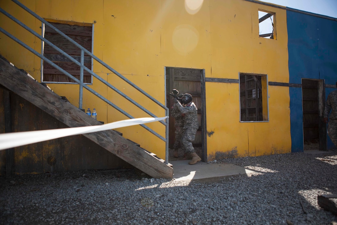 U.S. Army 11th Aviation Commands' Spc. Rafael McCarthy takes cover during the urban assault course event in the joint Best Warrior Competition March 22nd, 2016 at Ft. Knox, Kentucky. The Best Warrior Competition is a four-day competition that tests competitors' Army aptitude by going through urban warfare situations, board interviews, physical fitness tests, written exams, Warrior tasks and battle drills relevant to today's operational environment. (U.S. Army photo by Sgt. Amber Stephens)