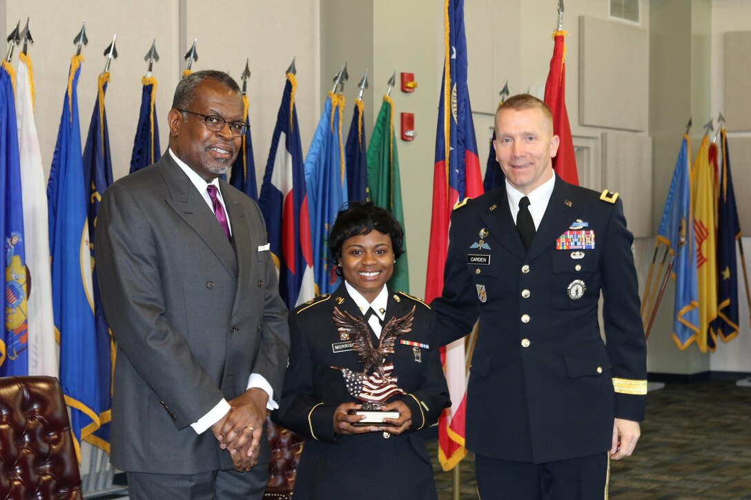 U.S. Army Reserve Spc. Shamar Morrison, a utilities equipment repairer from the 335th Signal Command (Theater), poses with Andre’ Jackson, editorial editor of the Atlanta Journal-Constitution (AJC) and Georgia Army National Guard Brig. Gen. Thomas Carden, Jr., after receiving the 2015 AJC Army Reserve Components Achievement award, March 22, 2016 at the Clay National Guard Center in Marietta, Ga. The AJC annually presents awards to recognize one soldier and one non-commissioned officer from Georgia based Army Reserve and Army National Guard units.