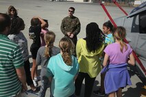 Capt. Daniel Willett, pilot with HMLA-269, shows students around multiple aircraft during the Student 2 Student field trip to Marine Corps Air Station New River, March 18. The S2S program’s goal is to continue to build connections between students, both from military families and non-military families, through encouraging teamwork to help build relationships.