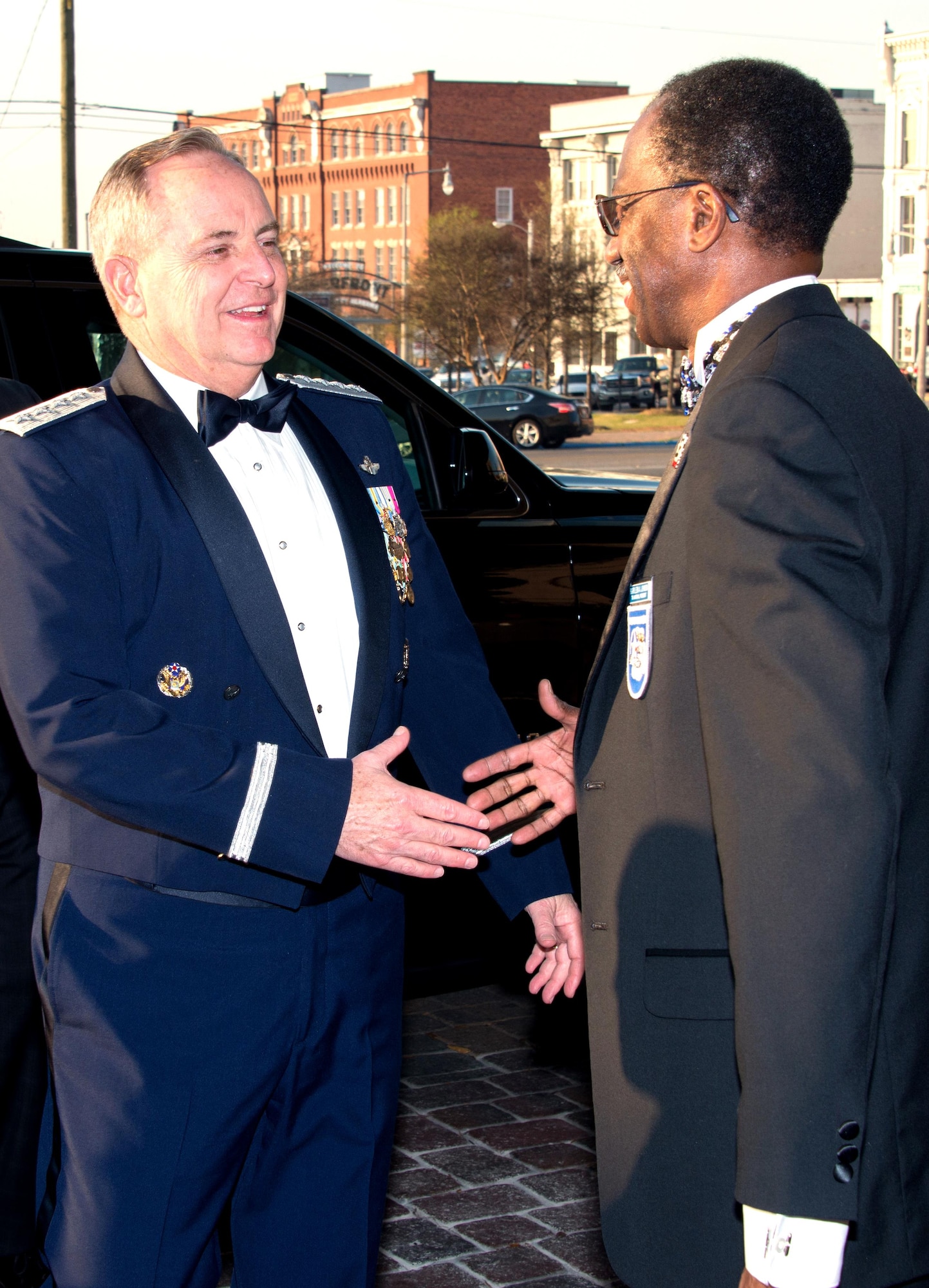 Retired Brig. Gen. Leon Johnson, right, greets Air Force Chief of Staff Mark A. Welsh III in downtown Montgomery, Ala., March 22, 2016, at the start of the Tuskegee Airmen Foundation’s 75th anniversary commemoration. Johnson is the foundation’s board chair and the national president of Tuskegee Airmen Inc. Welsh was inducted as an honorary member during the event. (U.S. Air Force photo/Trey Ward)