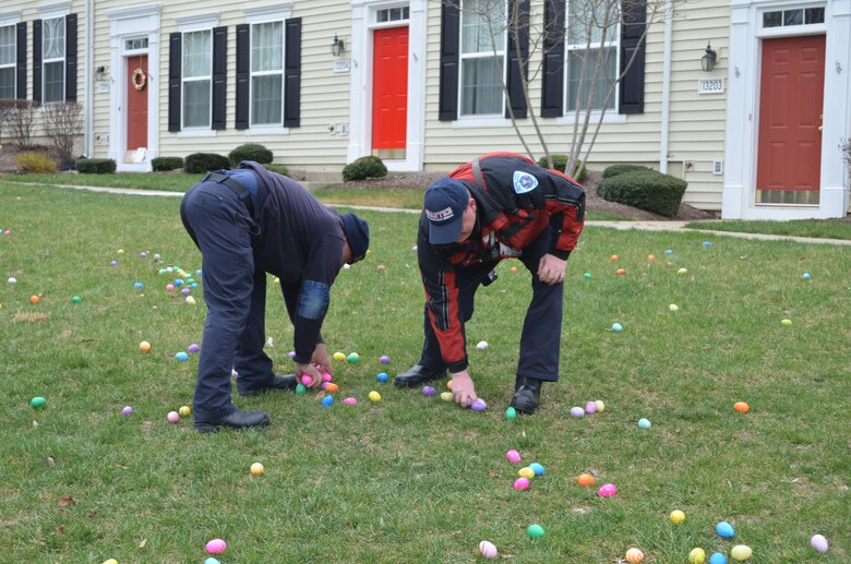 MARINE CORPS BASE QUANTICO, Va. — Firefighters from station 531 aboard Marine Corps Base Quantico help place eggs in the grass in front of the Lincoln Military Housing office for the annual Easter Egg Hunt. 