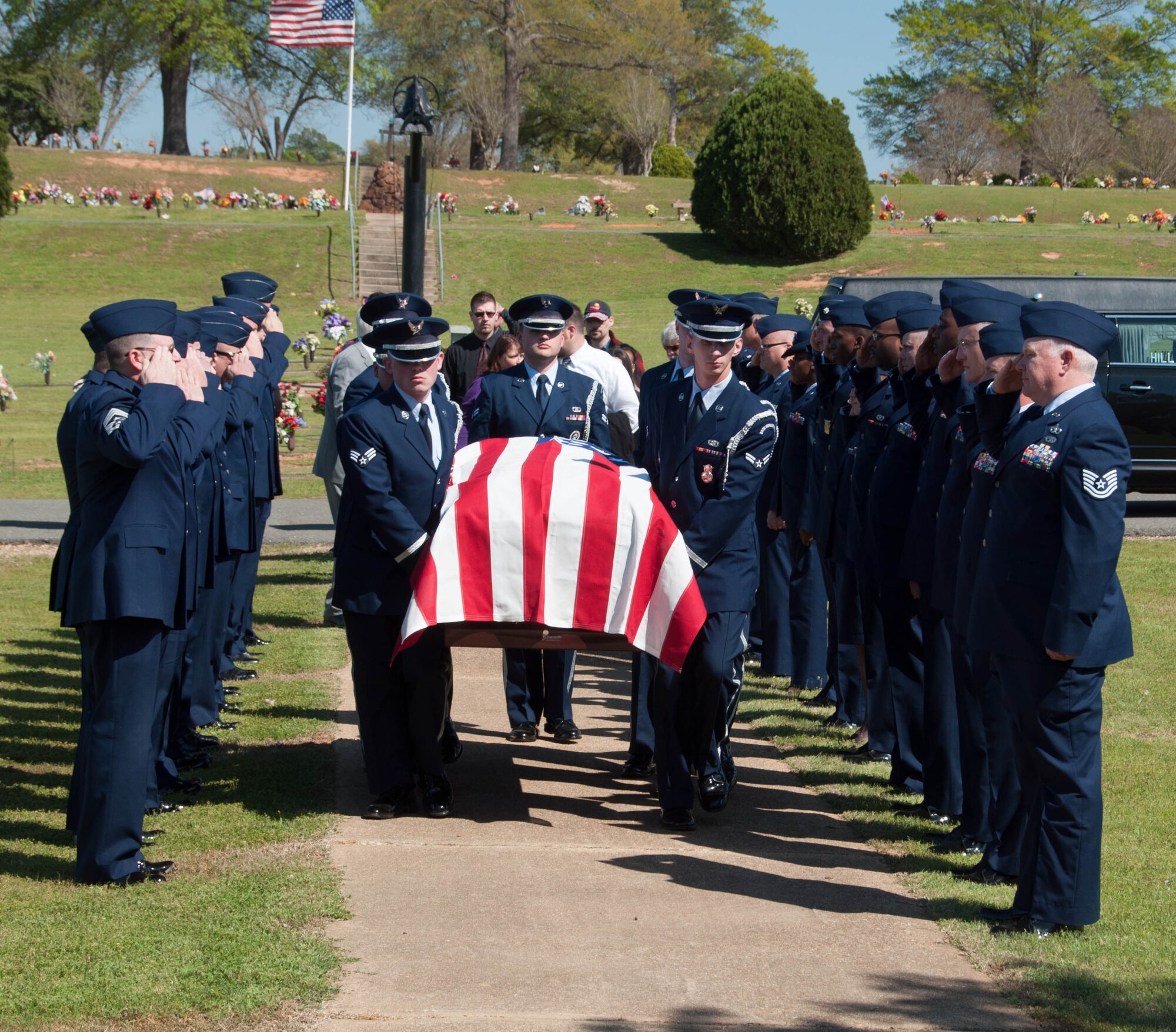 Members of the 307th Bomb Wing render a last salute to Retired Chief Master Sgt. Layton Wehling while he is carried to his final resting place March 22, 2016 at Hillcrest Cemetery in Bossier City, La. Wehling continued to work as a civilian in the 307th Bomb Wing on Barksdale Air Force Base, La. after retiring from the Air Force Reserves in 1991. (U.S. Air Force photo by Master Sgt. Laura Siebert/Released)