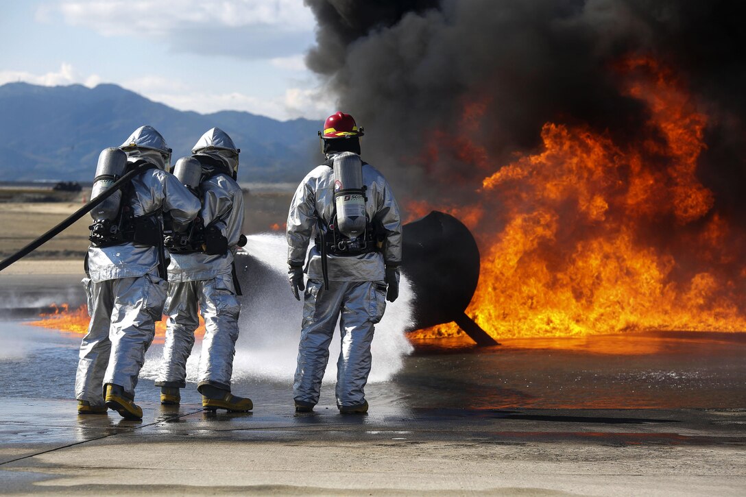 Marines conduct firefighting training to sharpen their skills at Marine Corps Air Station Iwakuni, Japan, March 11, 2016. The Marines, assigned to Aircraft Rescue Fire Fighting, conduct training in a controlled environment to better prepare for real life situations. Marine Corps photo by Lance Cpl. Jacob A. Farbo