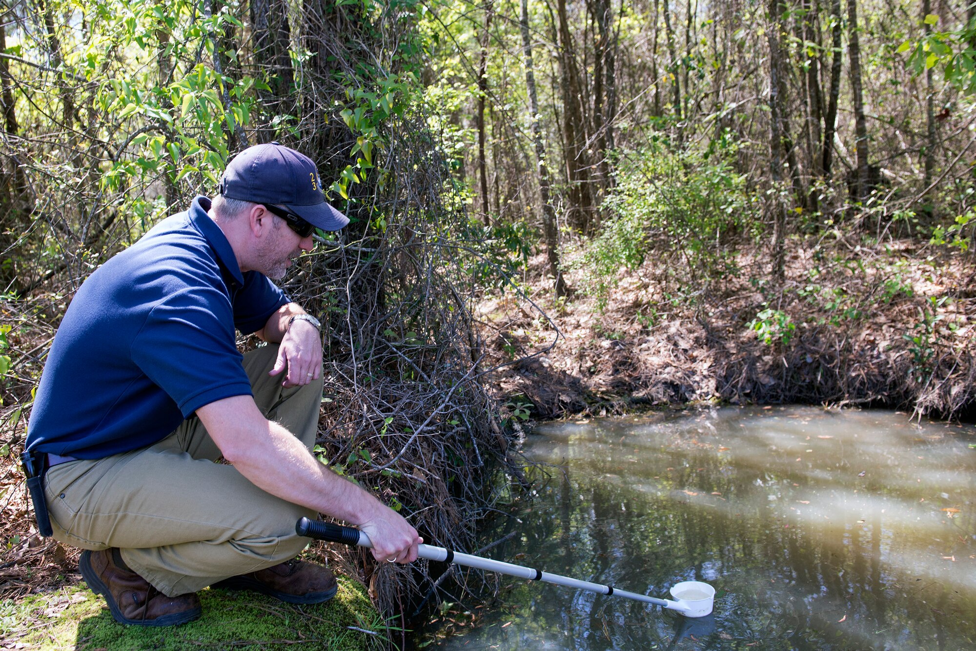 Bryon Kacprzyk, 23d Civil Engineer Squadron pest control supervisor, checks for mosquito larvae, March 23, 2016, at Moody Air Force Base, Ga. The 23d CES entomologists are responsible for surveying, identifying and recommending control measures for disease vectors, arthropod pests, hazardous plants and animals. (U.S. Air Force photo by Airman 1st Class Greg Nash/Released)  