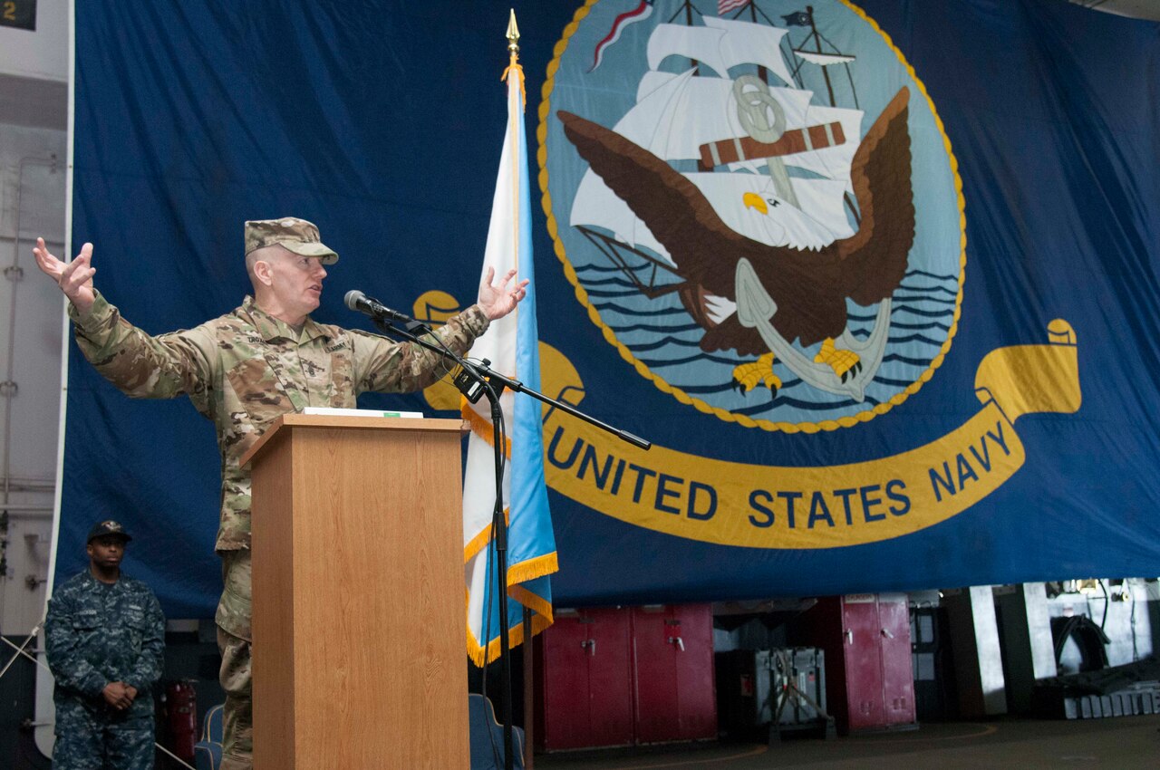 Army Command Sgt. Maj. John W. Troxell, the Senior Enlisted Advisor to the Chairman of the Joint Chiefs of Staff, addresses the crew of the aircraft carrier USS George Washington during an all-hands call in Norfolk, Va., March 23, 2016. Troxell visited the George Washington to highlight the chairman's priorities that include restoring joint readiness, improving joint warfighting and developing leaders. Navy photo by Petty Officer 1st Class Thomas Gagnier