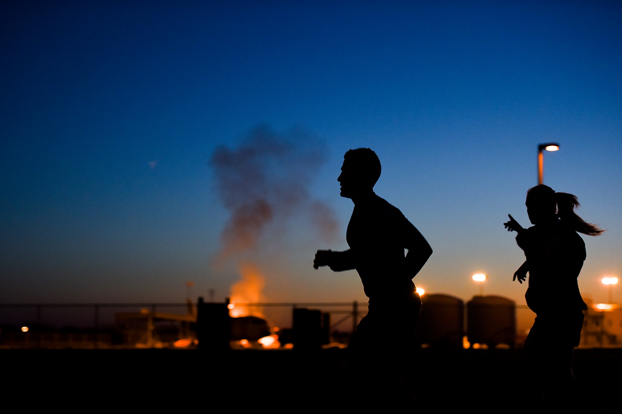 Rob Harris, KIDY Fox reporter, runs past the Louis F. Garland Department of Defense Fire Academy during a physical training session with the 17th Training Wing on Goodfellow Air Force Base, Texas, March 25, 2016. Harris participated in the exercise as part of a news series covering local fitness practices. (U.S. Air Force photo by Senior Airman Devin Boyer/Released)