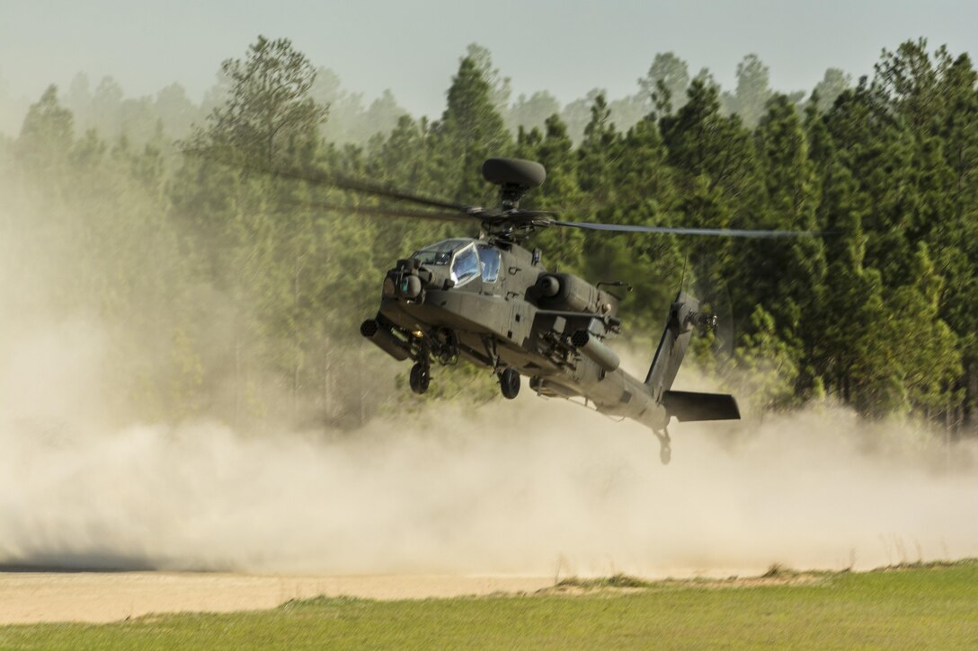 An Army National Guard AH-64 Apache Helicopter makes a surprise touch and go landing while Soldiers with the 108th Training Command (IET) were busy navigating to their points on the day land navigation course during the 108th's combined 2016 Best Warrior and Dril Sgt. of the Year competition held at Fort Jackson, S.C., March 21. (U.S. Army photo by Sgt. 1st Class Brian Hamilton/released)