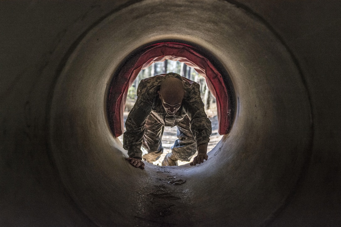 Sgt. 1st Class Ethan Feldner, 95th Training Division, crawls through a culvert on the endurance obstacle course at the 2016 108th Training Command (IET) Best Warrior competition at Fort Jackson, S.C., March 23. This year's Best Warrior competition will determine the top two drill sgts. who will represent the 108th Training Command (IET) in the TRADOC Drill Sgt. of the Year competition later this year at Fort Bragg, N.C. (U.S. Army photo by Sgt. 1st Class Brian Hamilton/released)