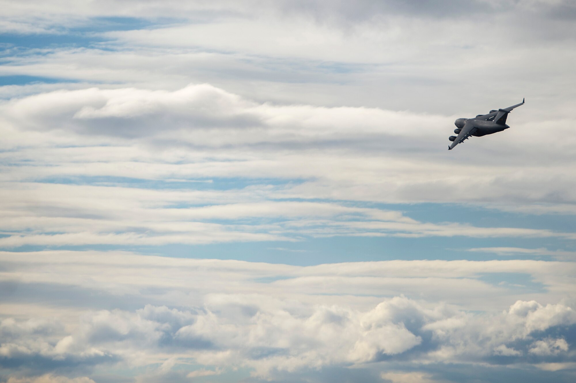 A U.S. Air Force C-17 Globermaster III flies over Joint Base Elmendorf Richardson during a training sortie, March 24, 2016.  Training sorties are imperative to pilot development and overall mission effectiveness. (U.S. Air Force photo by Senior Airman James Richardson/Released)