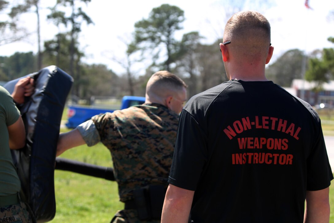 Sgt. Daniel Cornwell oversees an obstacle course during non-lethal weapons training at Marine Corps Air Station Cherry Point, N.C., March 17, 2016. Twelve Marines from various units participated in the training event with the Provost Marshal‘s Office. Marines were sprayed in the face with the potent substance and then maneuvered through an obstacle course simulating non-compliant threats. The training familiarized the participants with both the gear they will carry and the effects it will have on an individual being sprayed. Cornwell is a special reaction team Marine with Headquarters and Headquarters Squadron. (U.S. Marine Corps photo by Cpl. N.W. Huertas/Released)
