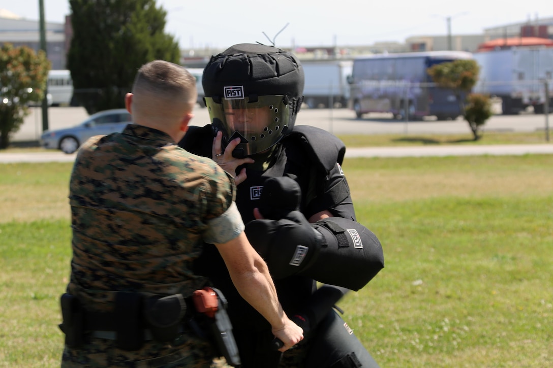 Lance Cpl. Brandon Murdock, left, conducts subduement techniques on Sgt. Patrick Hayes, right, during non-lethal weapons training at Marine Corps Air Station Cherry Point, N.C., March 17, 2016. Twelve Marines from various units participated in the training event with the Provost Marshal‘s Office. Marines were sprayed in the face with the potent substance and then maneuvered through an obstacle course simulating non-compliant threats. The training familiarized the participants with both the gear they will carry and the effects it will have on an individual being sprayed. Murdock is an avionics technician with Marine Aviation Logistics Squadron 14 and Hayes is a criminal investigator with Headquarters and Headquarters Squadron. (U.S. Marine Corps photo by Cpl. N.W. Huertas/Released)