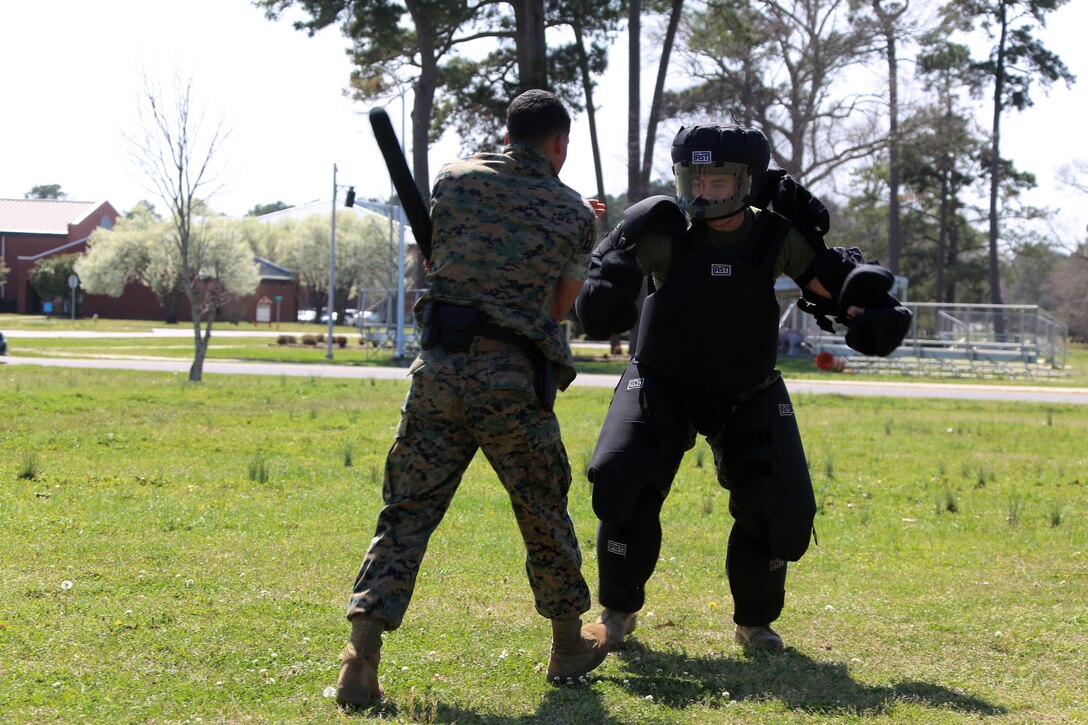 Lance Cpl. Xavier Tunstall, left, conducts subduement techniques on Sgt. Patrick Hayes, right, during non-lethal weapons training at Marine Corps Air Station Cherry Point, N.C., March 17, 2016. Twelve Marines from various units participated in the training event with the Provost Marshal‘s Office. Marines were sprayed in the face with the potent substance and then maneuvered through an obstacle course simulating non-compliant threats. The training familiarized the participants with both the gear they will carry and the effects it will have on an individual being sprayed. Tunstall is an administrative clerk and Hayes is a criminal investigator, both with Headquarters and Headquarters Squadron. (U.S. Marine Corps photo by Cpl. N.W. Huertas/Released)