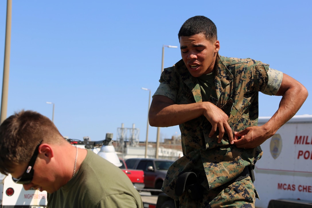 Lance Cpl. Xavier Tunstall simulates handcuffing personnel during non-lethal weapons training at Marine Corps Air Station Cherry Point, N.C., March 17, 2016. Twelve Marines from various units participated in the training event with the Provost Marshal‘s Office. Marines were sprayed in the face with the potent substance and then maneuvered through an obstacle course simulating non-compliant threats. The training familiarized the participants with both the gear they will carry and the effects it will have on an individual being sprayed. Tunstall is an administrative clerk with Headquarters and Headquarters Squadron. (U.S. Marine Corps photo by Cpl. N.W. Huertas/Released)