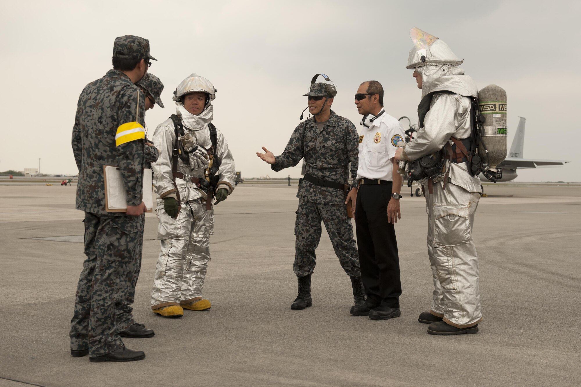 Japan Air Self-Defense Force 9th Wing members and U.S. Air Force 18th Civil Engineer Squadron firefighters conduct aircraft barrier recovery training March 15, 2016, at Naha Air Base, Japan. Bilateral training between the two nations enhanced unit interoperability should the need arise for Kadena Air Base to provide inflight emergency support for JASDF aircraft. (U.S. Air Force photo by Senior Airman Peter Reft)