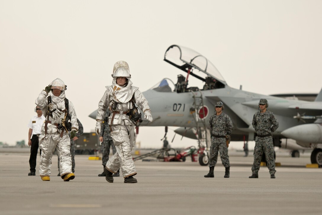 U.S. Air Force 18th Civil Engineer Squadron firefighters and Japan Air Self-Defense Force aircrews conduct aircraft barrier recovery training March 15, 2016, at Naha Air Base, Japan. The two units conducted flight line training to enhance readiness in the event of JASDF aircraft emergencies requiring Kadena Air Base support. (U.S. Air Force photo by Senior Airman Peter Reft)