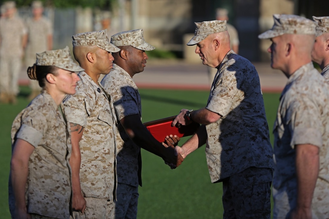 Lieutenant General David H. Berger, commanding general, I Marine Expeditionary Force, presents Marines assigned to Truck Company, Headquarters Battalion, 1st Marine Division, with the Marine Corps Motor Transportation Unit of the Year award, aboard Marine Corps Base Camp Pendleton, March 25, 2016. The Marines with Truck Co. demonstrated exceptional technical and tactical proficiency and dependability which earned them the award.