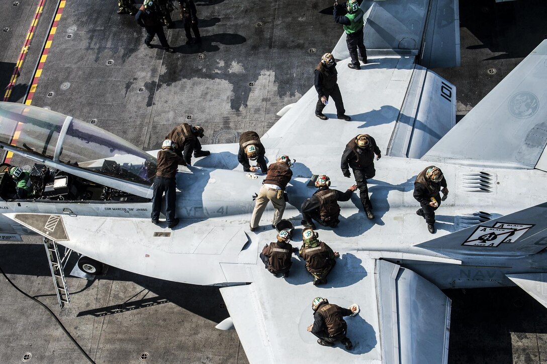 Sailors clean an F/A-18F Super Hornet on the flight deck of the aircraft carrier USS John C. Stennis near the Korean peninsula, March 23, 2016. The Super Hornet is assigned to Strike Fighter Squadron 41. The Stennis is on a regularly scheduled deployment to the U.S. 7th Fleet area of responsibility. Navy photo by Petty Officer 3rd Class Andre T. Richard