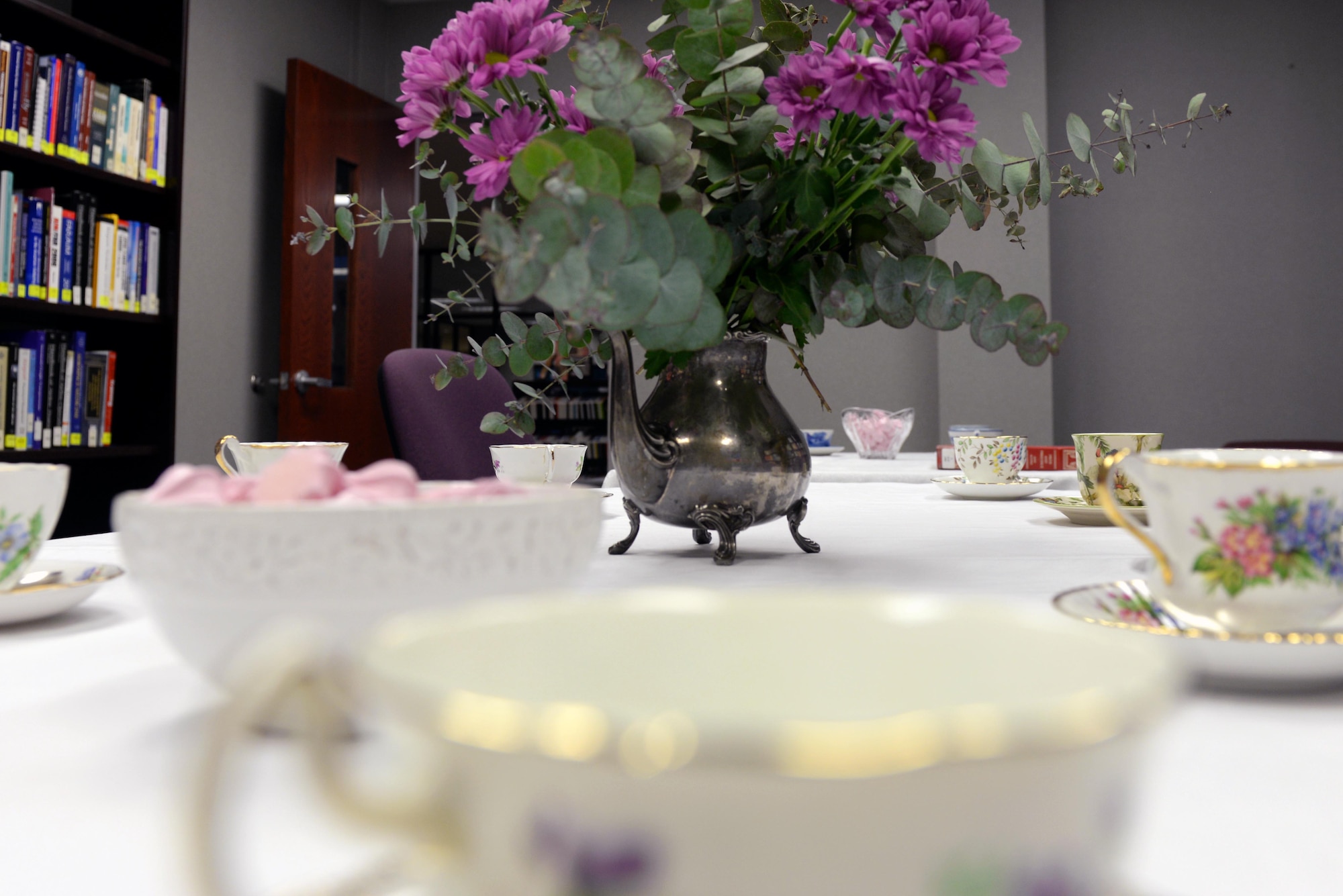 The hosts of the Make It Better Book Club prepare a Jane Austen tea party themed meeting to discuss the month’s reading goal, March 16, 2016, inside the library at Seymour Johnson Air Force Base, North Carolina. The MIB Book Club coordinated with the Brown Bag Book Club to read books by Jane Austen, the author of Pride and Prejudice, Sense and Sensibility, as well as other classic novels. The Book Club provides Team Seymour Airmen the opportunity to converse about books while enjoying drinks and snacks. (U.S. Air Force photo/Airman 1st Class Ashley Williamson)