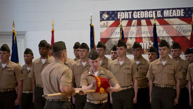 Marines with Marine Corps Cyberspace Warfare Group prepare to post the guidon during an activation of command ceremony of Marine Corps cyberspace warfare group at Fort George G. Meade, Maryland, March 25, 2016. The mission of MCCYWG is to man, train and equip Marine Cyberspace mission teams to perform both defensive and offensive cyber operations in support of United States Cyber Command and Marine Forces Cyberspace Command.