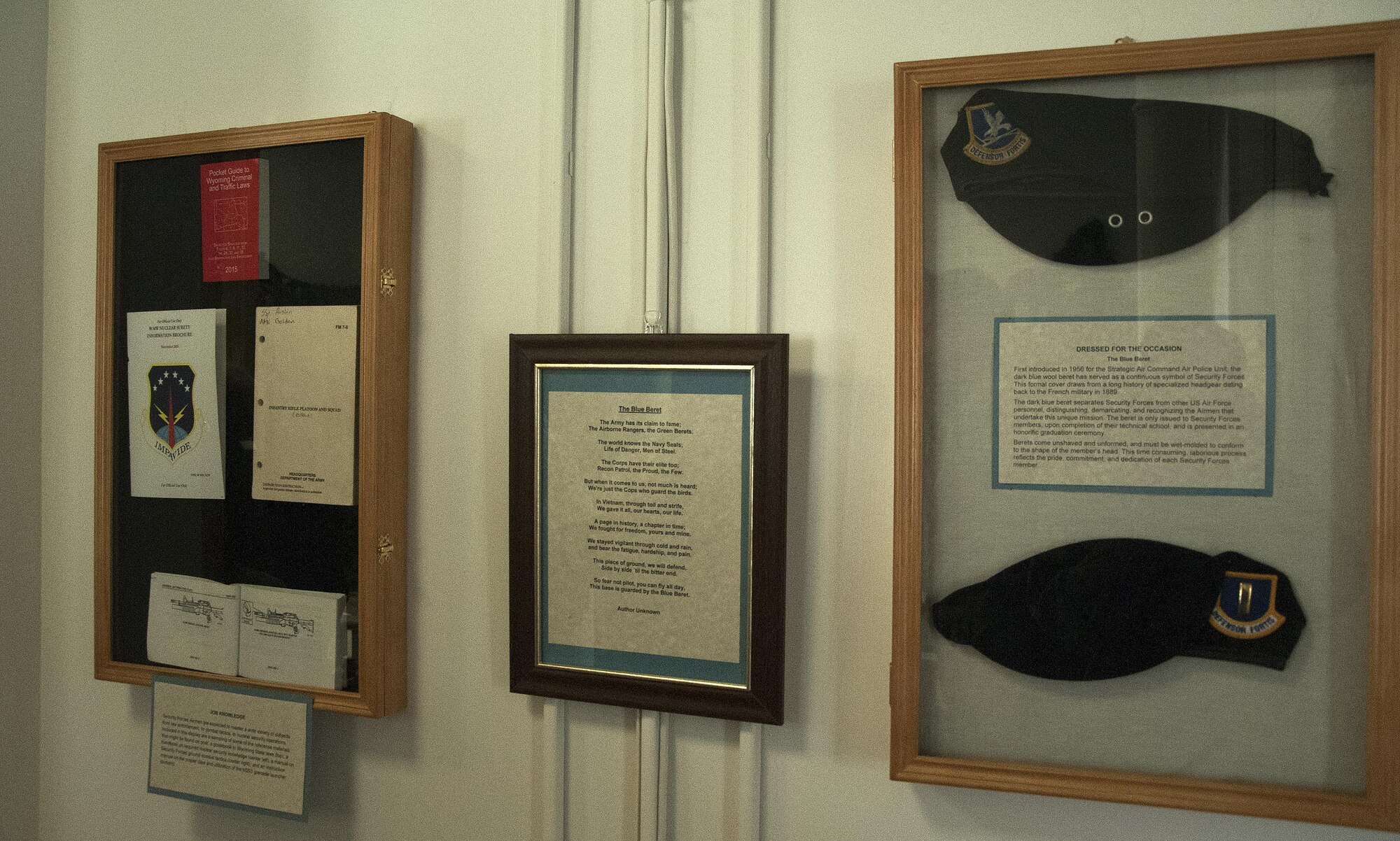 Security forces training manuals and berets are displayed on a wall as part of a new exhibit, “Security Forces: The Tale of the Blue Beret,” March 21, 2016, inside the Warren ICBM and Heritage Museum on F.E. Warren Air Force Base, Wyo. The exhibit highlights various aspects and equipment used by defenders of the Mighty Ninety to accomplish their mission. (U.S. Air Force photo by Senior Airman Brandon Valle)