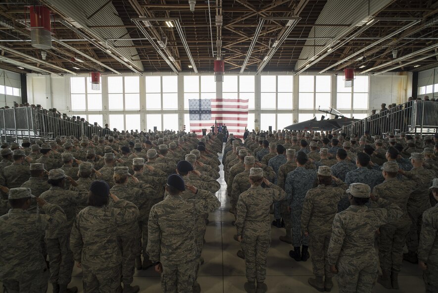 Airmen of the 366th Fighter Wing salute during the National Anthem, March 24, 2016, at Mountain Home Air Force Base, Idaho. Col. Jefferson O'Donnell took command of the wing after serving as the vice wing commander for the previous nine months. (U.S. Air Force photo by Tech. Sgt. Samuel Morse/RELEASED)