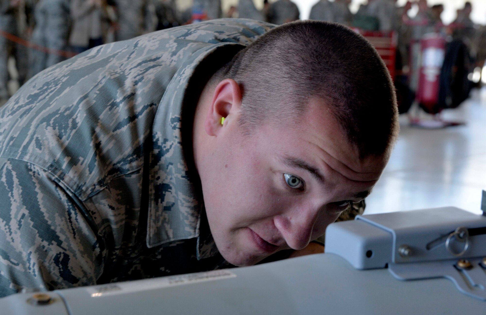 Airman 1st Class Stuart, 43nd Aircraft Maintenance Squadron weapons load crew member, inspects a munition at the 2015 Load Crew of the Year competition March 9, 2016, at Creech Air Force Base, Nevada. During the competition, load crew members check munitions to ensure they are serviceable. (U.S Air Force photo by Airman 1st Class Kristan Campbell/Released)