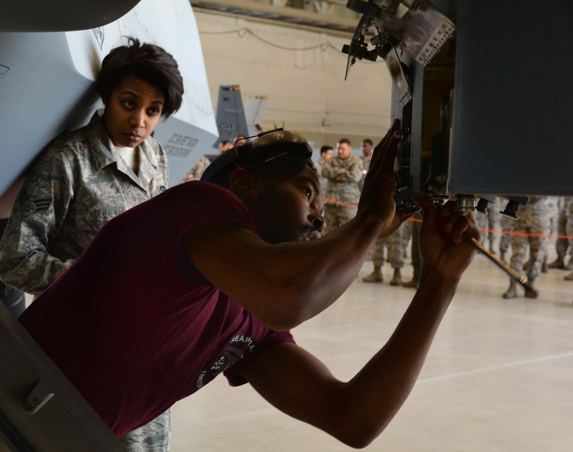 Airman 1st Class Quantavious, 432nd AMXS weapons load crew member, performs maintenence on an MQ-9 Reaper weapons pylon during the 2015 Load Crew of the Year competition March 10, 2016, at Creech Air Force Base, Nevada. Load crew members load munitions onto the pylons as a part of the competition.
