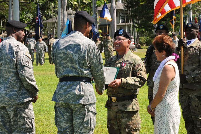 U.S. Army Pacific Deputy Commanding General - National Guard, Maj. Gen. Gary Hara (center-right), receives his retirement award from Gen. Vincent Brooks (center-left), USARPAC Commanding General, during a Flying "V" ceremony held at historic Palm Circle, Fort Shafter, Hawaii, March 23, 2016. The ceremony honored Hara's retirement after 47 years of service. He had been with USARPAC since 2013, during which time he operated as the Deputy Commanding General of the ARNG after USARPAC was elevated from a 3-star command to a 4-star command as part of the Asia-Pacific strategic rebalance. (U.S. Army photo by Staff Sgt. Chris McCullough, USARPAC Public Affairs)