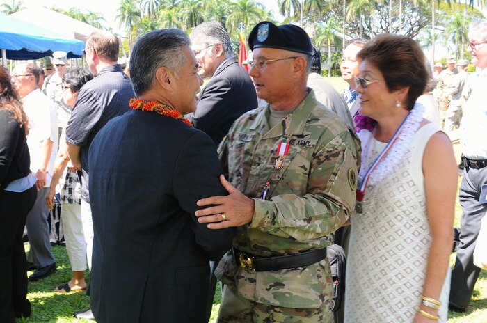 Governor of Hawaii, David Ige (left), congratulates Hawaii native, Maj. Gen. Gary Hara (center), U.S. Army Pacific Deputy Commanding General - National Guard following his retirement ceremony held at historic Palm Circle, Fort Shafter, Hawaii, March 23, 2016. Ige thanked Hara for his contributions to Hawaii and the nation. "General Hara, you have served our community, state and nation admirably, and our citizens of Hawaii are appreciative of your dedication, hard work and leadership," said Ige. "We wish you and your ohana the very best as you begin to pen your very first chapter of your new book of life called 'Retirement.'" (U.S. Army photo by Staff Sgt. Chris McCullough, USARPAC Public Affairs)